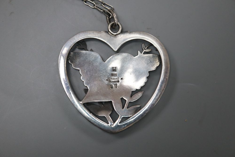 A George Jensen sterling Robin & fearn heart shaped pendant, with white metal necklace, no. 97, 41mm, gross 15.6 grams.